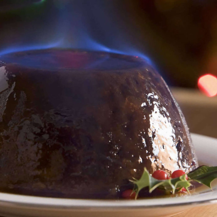 A flaming Christmas pudding with blue flame