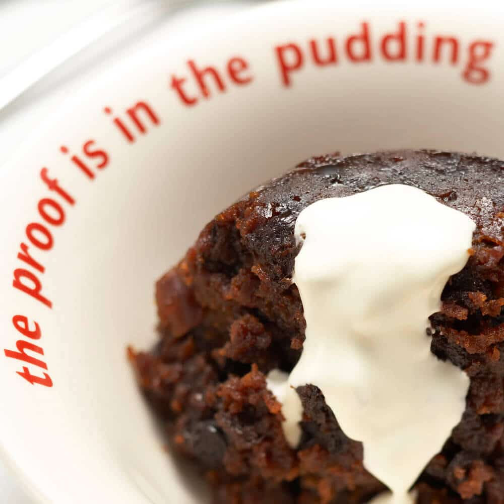 Figgy's Christmas Pudding on a plate with cream