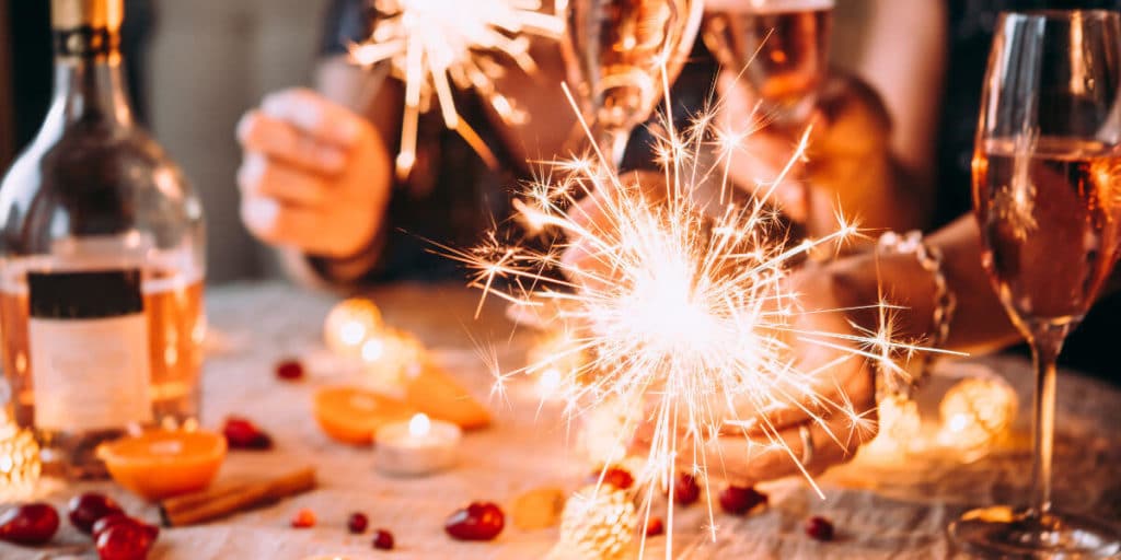 Christmas table with sparklers and wine glasses