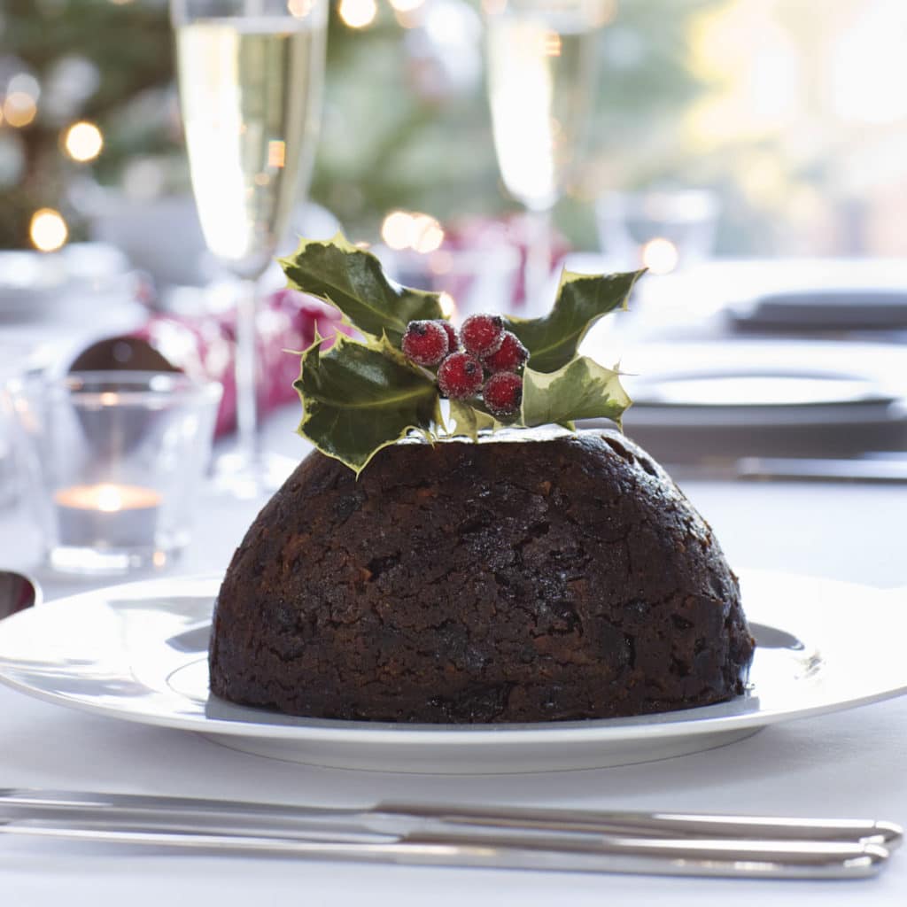 Closeup of Figgy's Christmas pudding with holly on top on a plate